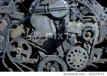 Close Up of an Old Car Engine with Visible Belts and Gears Close Up of an Old Car Engine with Visible Belts and Gears 141074721