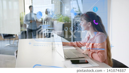 Working woman in salmon blouse typing on laptop at meeting table, with AR overlays, smartphone Working woman in salmon blouse typing on laptop at meeting table, with AR overlays, smartphone 141074887
