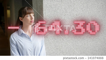 Gazing woman wearing striped shirt, standing in corridor by concrete wall with red -64 Gazing woman wearing striped shirt, standing in corridor by concrete wall with red -64 141074888