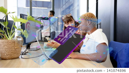 Collaborating women analysts reviewing laptop, charts, AR overlays at office in white and dark tops Collaborating women analysts reviewing laptop, charts, AR overlays at office in white and dark tops 141074896