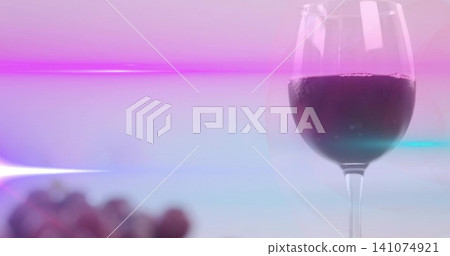 Featuring single stemmed wine glass holding red wine on tabletop, with blurred grapes, copy space Featuring single stemmed wine glass holding red wine on tabletop, with blurred grapes, copy space 141074921