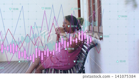 Holding white ceramic mug senior woman in pink dress sitting on porch, showing financial charts 141075384