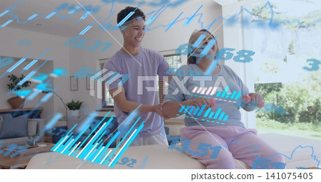 Helping senior woman lifting pink weights on mat at home with therapist supporting, HUD overlays Helping senior woman lifting pink weights on mat at home with therapist supporting, HUD overlays 141075405