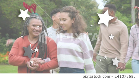 Walking woman, child holding hands in park, red sweater, pastel, reindeer antlers, star overlays Walking woman, child holding hands in park, red sweater, pastel, reindeer antlers, star overlays 141075683