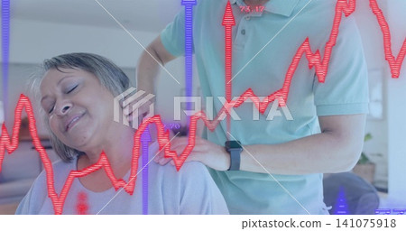 Massaging carer pressing senior woman neck at home on couch green polo lilac sweater watch overlays Massaging carer pressing senior woman neck at home on couch green polo lilac sweater watch overlays 141075918