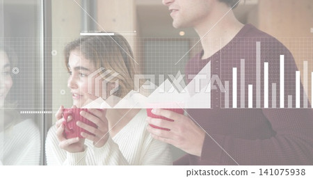 Holding red mugs, couple wearing cream and maroon knits standing at kitchen window, area or bar char Holding red mugs, couple wearing cream and maroon knits standing at kitchen window, area or bar char 141075938