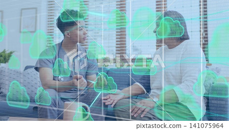 Speaking clinician in gray scrubs with stethoscope holding senior's hand at home cloud overlays Speaking clinician in gray scrubs with stethoscope holding senior's hand at home cloud overlays 141075964