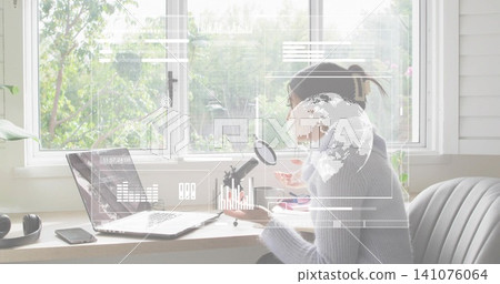 Recording host in sweater speaking into mic at home desk by window, laptop overlays, copy space Recording host in sweater speaking into mic at home desk by window, laptop overlays, copy space 141076064