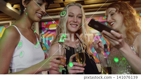 Holding champagne flutes, three women in party wear checking smartphone at bar, with AR icons Holding champagne flutes, three women in party wear checking smartphone at bar, with AR icons 141076139