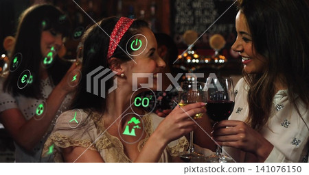 Clinking wine glasses, women wearing lace top and studded blouse smiling at bar, green AR icons Clinking wine glasses, women wearing lace top and studded blouse smiling at bar, green AR icons 141076150
