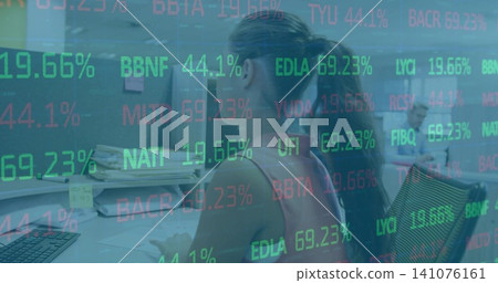Typing Asian woman wearing sleeveless top at office desk, with monitors, papers, stock ticker Typing Asian woman wearing sleeveless top at office desk, with monitors, papers, stock ticker 141076161
