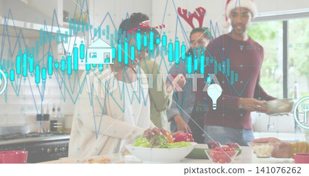Preparing four adults wearing festive hats serving large salad bowl in kitchen, with digital charts 141076262