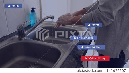 Washing woman in gray sweater lathering hands at sink with blue dispenser and badges, copy space Washing woman in gray sweater lathering hands at sink with blue dispenser and badges, copy space 141076307