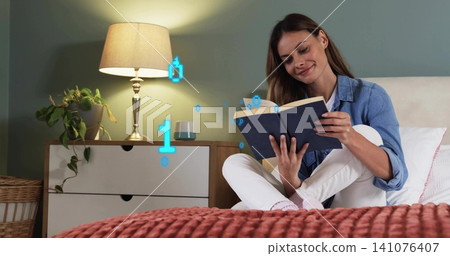 Reading mid-adult woman on bedroom bed, wearing denim-shirt holding navy-hardcover, floating bits Reading mid-adult woman on bedroom bed, wearing denim-shirt holding navy-hardcover, floating bits 141076407
