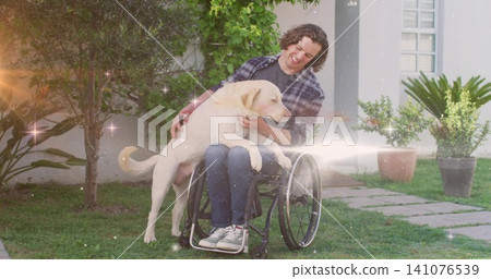 Smiling mid-adult man in plaid shirt holding large Labrador on lap in grassy yard with wheelchair Smiling mid-adult man in plaid shirt holding large Labrador on lap in grassy yard with wheelchair 141076539