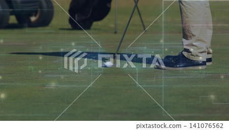Placing golfer's legs, putting putter behind golf ball on green, khaki pants, navy shoes, overlays Placing golfer's legs, putting putter behind golf ball on green, khaki pants, navy shoes, overlays 141076562