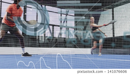 Swinging woman on right in black shorts hitting paddle on blue court, analytics overlay, copy space Swinging woman on right in black shorts hitting paddle on blue court, analytics overlay, copy space 141076606