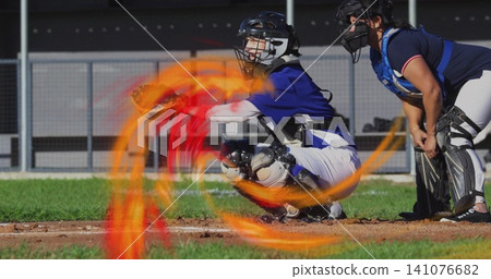 Crouching catcher extending mitt at home plate on dirt and grass field, with helmet, flame overlay Crouching catcher extending mitt at home plate on dirt and grass field, with helmet, flame overlay 141076682