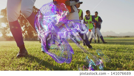 Training female soccer players moving on sunlit turf, white pants, neon vests, purple overlay Training female soccer players moving on sunlit turf, white pants, neon vests, purple overlay 141076689
