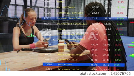 Checking pair in workout gear at gym tapping phones, showing market overlay, charger, pink band Checking pair in workout gear at gym tapping phones, showing market overlay, charger, pink band 141076705