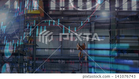 Hanging orange hoist pulley with hook against corrugated wall in factory, with ladders and data Hanging orange hoist pulley with hook against corrugated wall in factory, with ladders and data 141076743