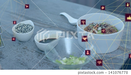 Showing ceramic bowl topped with greens on gray table with spoon sauces glass bowl digital overlay Showing ceramic bowl topped with greens on gray table with spoon sauces glass bowl digital overlay 141076778