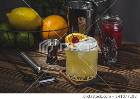 Whiskey Sour Cocktail in old fashioned glass with water drops, dark background Whiskey Sour Cocktail in old fashioned glass with water drops, dark background 141077198