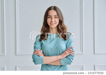 Confident teen girl with crossed arms in mint top Confident teen girl with crossed arms in mint top 141077830