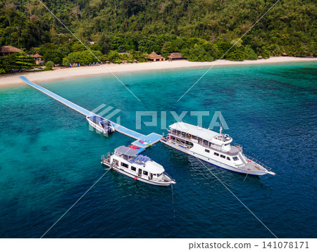 Aerial view of tropical beach landscape with tour boats at Nyaung Oo Phee island in Myanmar Aerial view of tropical beach landscape with tour boats at Nyaung Oo Phee island in Myanmar 141078171