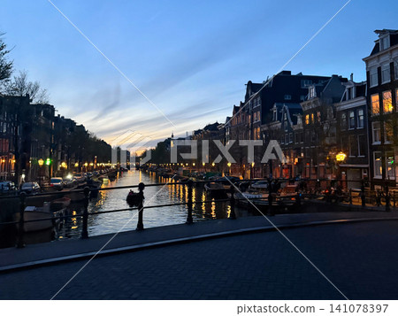 Traditional building and canal at night in Amsterdam Netherlands Traditional building and canal at night in Amsterdam Netherlands 141078397
