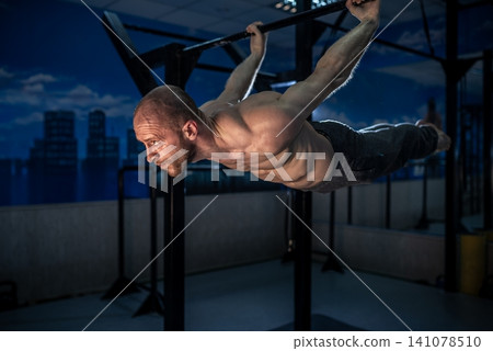 Man balancing horizontally on a high bar in a front lever position Man balancing horizontally on a high bar in a front lever position 141078510