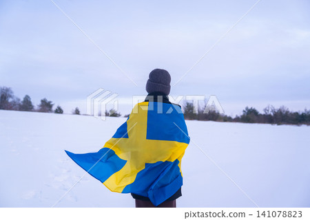 Swedish Patriot Woman With National Flag Of Sweden On White Snow Nature Swedish Patriot Woman With National Flag Of Sweden On White Snow Nature 141078823
