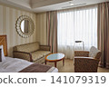Hotel room with sofa and large window 141079319