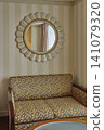 Sofa and designer mirror in a hotel room 141079320