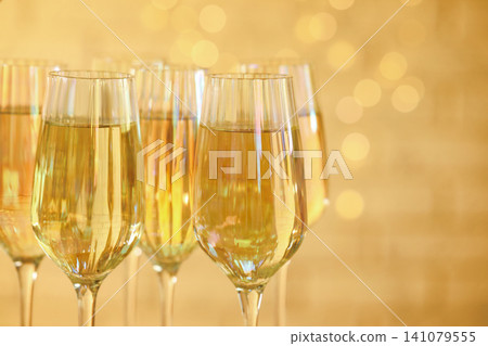Glasses of champagne against blurred lights, closeup 141079555