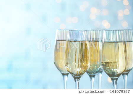 Glasses of champagne against blurred lights, closeup. Space for text 141079557