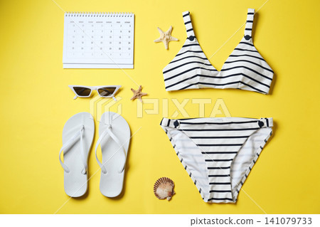 Flat lay composition with beach objects on yellow background Flat lay composition with beach objects on yellow background 141079733