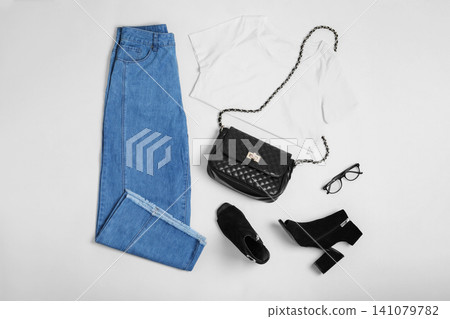 Stylish outfit with jeans on white background, top view Stylish outfit with jeans on white background, top view 141079782