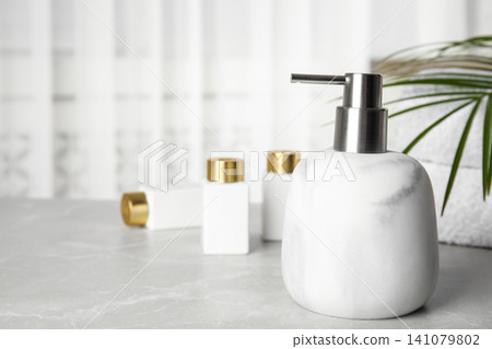 Modern marble soap dispenser on light table Modern marble soap dispenser on light table 141079802