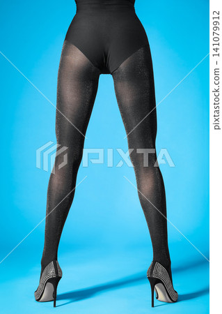 Woman wearing black tights and stylish shoes on light grey background, closeup of legs Woman wearing black tights and stylish shoes on light grey background, closeup of legs 141079912