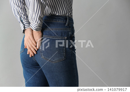 Woman wearing black tights and stylish shoes on light grey background, closeup of legs 141079917