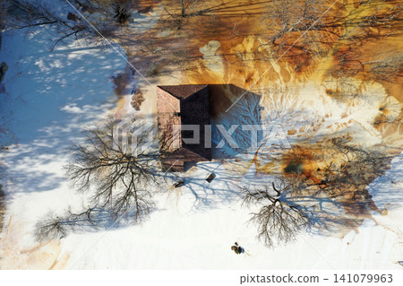 Aerial view choked sinking village house by acid mine drainage toxic waters Aerial view choked sinking village house by acid mine drainage toxic waters 141079963