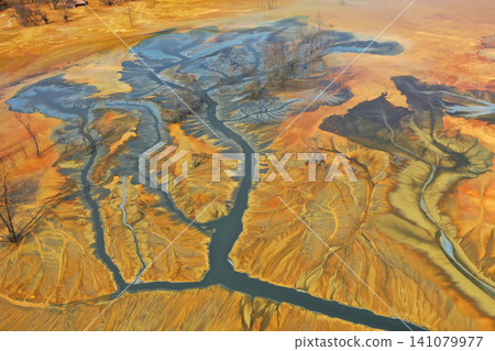 Aerial view of surreal toxic water stream from copper mine in decanting lake. Natural pattern Aerial view of surreal toxic water stream from copper mine in decanting lake. Natural pattern 141079977
