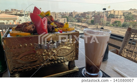 Close up of grilled kebab mix and a glass of iced mocha Close up of grilled kebab mix and a glass of iced mocha 141080007