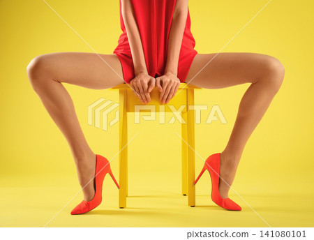 Woman wearing tights and stylish red shoes on yellow background, closeup Woman wearing tights and stylish red shoes on yellow background, closeup 141080101