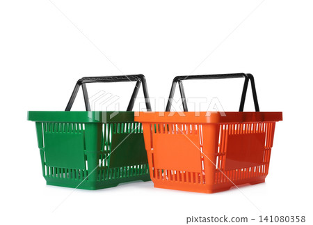 Color plastic shopping baskets isolated on white Color plastic shopping baskets isolated on white 141080358