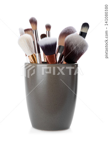 Set of professional makeup brushes in holder isolated on white Set of professional makeup brushes in holder isolated on white 141080380