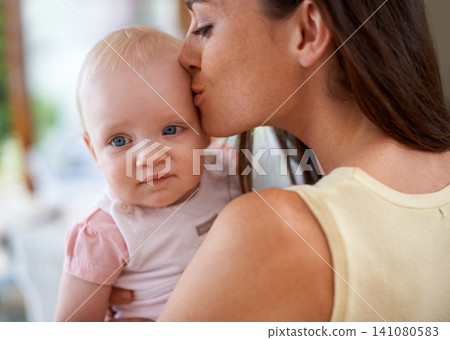 Family, kiss and mom with baby in home for bonding, relationship and care for motherhood. Happy, parenting and mother carrying newborn infant for child development, love and affection in house 141080583