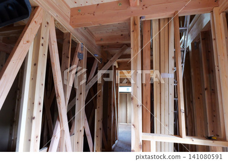 Timber Framing Structure of Residential Building at Construction Site, Low Angle View Timber Framing Structure of Residential Building at Construction Site, Low Angle View 141080591