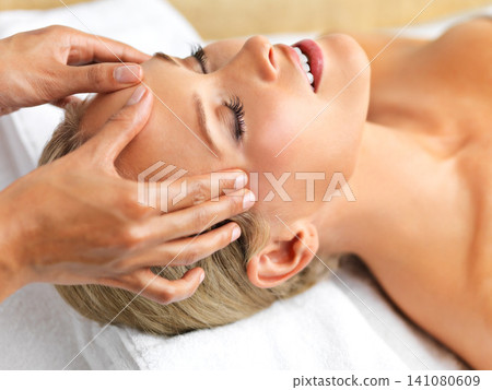 Closeup, woman or head massage to relax, mind or wellness as luxury, self care or mental health. Hand, client or peace to oil, facial or sleep of dream, beauty salon or table in cosmetology clinic Closeup, woman or head massage to relax, mind or wellness as luxury, self care or mental health. Hand, client or peace to oil, facial or sleep of dream, beauty salon or table in cosmetology clinic 141080609